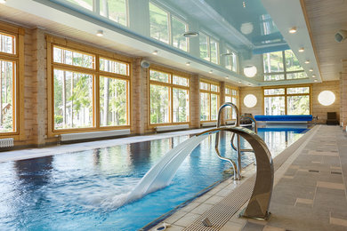 Rural indoor rectangular swimming pool in Saint Petersburg with a water feature.