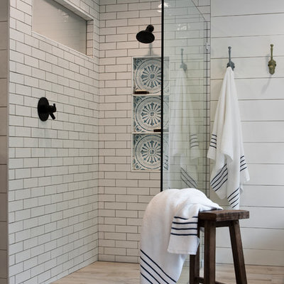 Bathroom - mid-sized country master white tile and subway tile light wood floor and beige floor bathroom idea in New York with furniture-like cabinets, dark wood cabinets, white walls, an undermount sink and black countertops