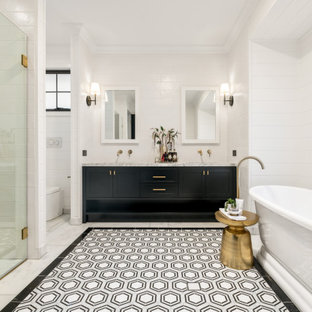 Country bathroom in Brisbane with shaker cabinets, black cabinets, a freestanding tub, a curbless shower, white tile, white walls, an undermount sink, multi-coloured floor, a hinged shower door, grey benchtops, an enclosed toilet, a double vanity, a built-in vanity and planked wall panelling.