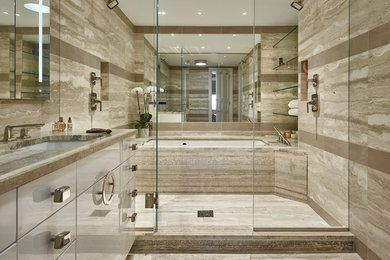 Example of a mid-sized trendy master beige tile and porcelain tile limestone floor and beige floor wet room design in New York with flat-panel cabinets, white cabinets, an undermount tub, beige walls, an undermount sink, limestone countertops and a hinged shower door