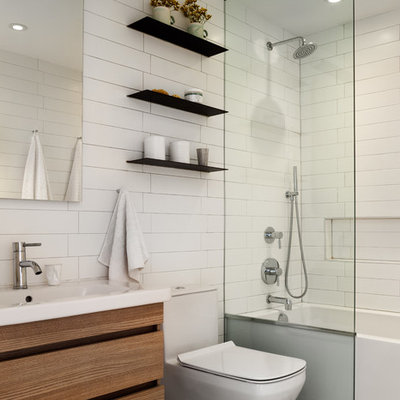 Example of a small trendy kids' white tile gray floor bathroom design in New York with a one-piece toilet, white walls, medium tone wood cabinets and a console sink