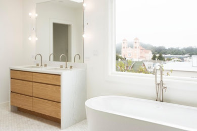 Bathroom - large contemporary master mosaic tile floor and multicolored floor bathroom idea in San Francisco with flat-panel cabinets, light wood cabinets, white walls, an undermount sink, marble countertops and white countertops