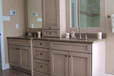 Example of a transitional beige tile bathroom design in Toronto with an undermount sink, furniture-like cabinets, light wood cabinets and quartz countertops