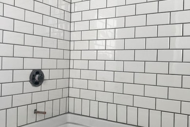 Example of a minimalist white tile and subway tile porcelain tile and gray floor bathroom design in Other with a two-piece toilet, gray walls, a vessel sink and wood countertops