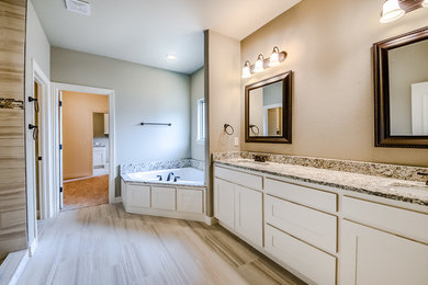 Example of a large transitional master porcelain tile and beige floor bathroom design in Other with shaker cabinets, white cabinets, beige walls, an undermount sink, granite countertops and multicolored countertops
