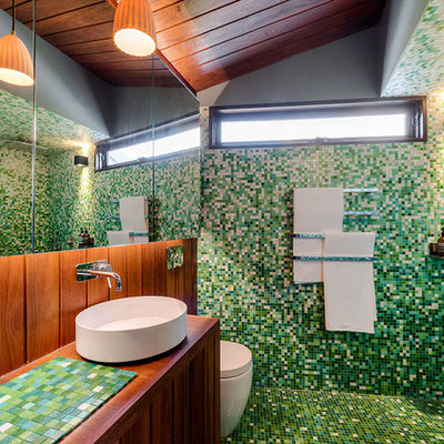 Inspiration for a contemporary green tile and mosaic tile mosaic tile floor bathroom remodel in Melbourne with a one-piece toilet, green walls, a vessel sink, tile countertops and green countertops
