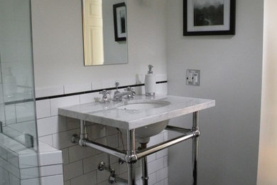 Small elegant 3/4 white tile and ceramic tile ceramic tile corner shower photo in San Francisco with a console sink, marble countertops and gray walls