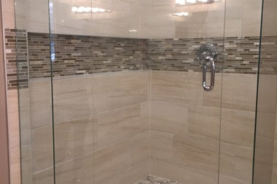 Corner shower - large contemporary master beige tile and porcelain tile porcelain tile corner shower idea in Little Rock with an undermount sink and granite countertops