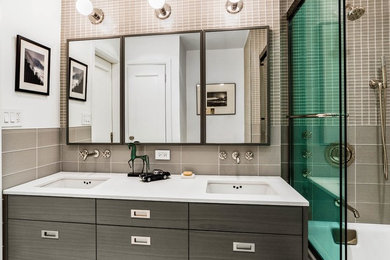 Example of a mid-sized minimalist kids' glass tile marble floor bathroom design in Other with flat-panel cabinets, gray cabinets, a one-piece toilet, white walls, an undermount sink and solid surface countertops