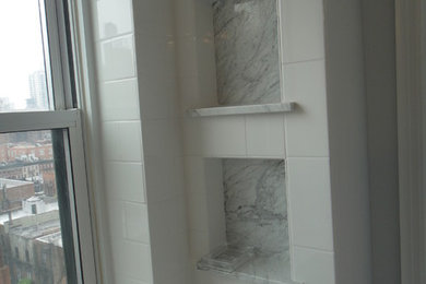 Example of a classic master white tile and porcelain tile porcelain tile bathroom design in New York with an undermount sink, marble countertops, a wall-mount toilet and white walls