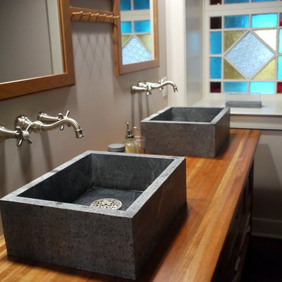 Example of a cottage bathroom design in Other with a vessel sink and wood countertops