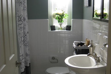Diseño de cuarto de baño tradicional pequeño con lavabo con pedestal, bañera empotrada, combinación de ducha y bañera, sanitario de dos piezas, baldosas y/o azulejos blancos, baldosas y/o azulejos de cerámica, paredes azules y suelo de baldosas de cerámica