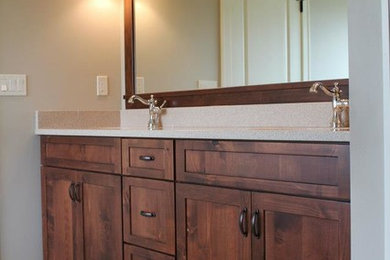 Medium sized traditional ensuite bathroom in Cedar Rapids with shaker cabinets, dark wood cabinets, beige walls, ceramic flooring, a submerged sink, beige floors and terrazzo worktops.