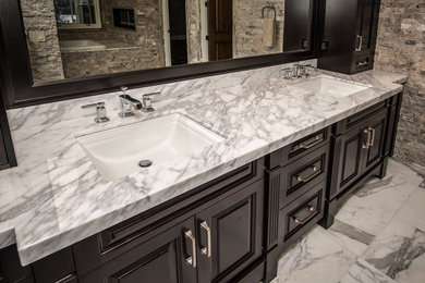 Inspiration for a timeless white tile and stone tile bathroom remodel in Vancouver with an undermount sink, recessed-panel cabinets, dark wood cabinets and marble countertops