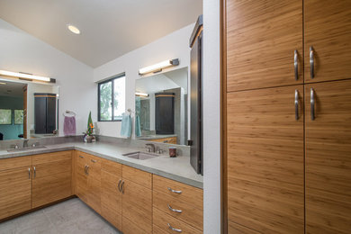 Mid-sized trendy master gray tile and ceramic tile ceramic tile doorless shower photo in San Diego with a drop-in sink, flat-panel cabinets, light wood cabinets, granite countertops, a one-piece toilet and white walls