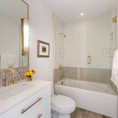 Inspiration for a mid-sized contemporary 3/4 white tile and porcelain tile brown floor and porcelain tile bathroom remodel in Minneapolis with flat-panel cabinets, white cabinets, white walls, an undermount sink, a hinged shower door, white countertops, a one-piece toilet and quartz countertops