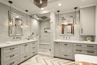 Inspiration for a mid-sized transitional master white tile and subway tile medium tone wood floor and beige floor bathroom remodel in San Francisco with recessed-panel cabinets, gray cabinets, a one-piece toilet, gray walls, an undermount sink, quartzite countertops, a hinged shower door and white countertops