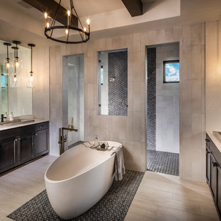 Inspiration för ett mycket stort funkis beige beige en-suite badrum, med skåp i mörkt trä, ett fristående badkar, en dubbeldusch, klinkergolv i porslin, ett nedsänkt handfat, skåp i shakerstil, beige kakel, beige väggar och beiget golv