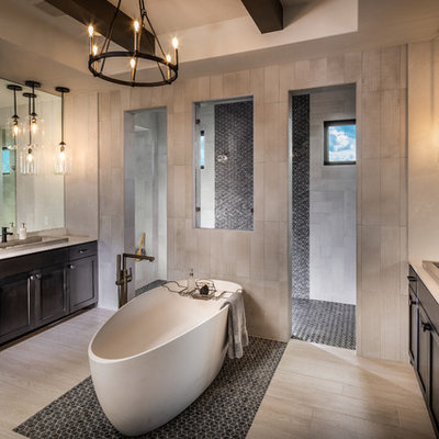 Huge trendy master beige tile porcelain tile and beige floor bathroom photo in Austin with dark wood cabinets, a drop-in sink, shaker cabinets, beige walls and beige countertops