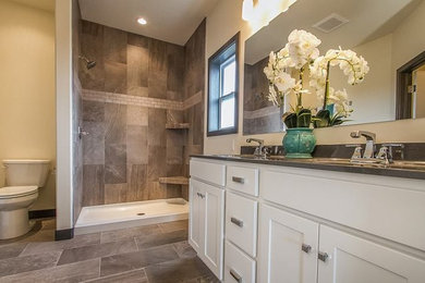 Inspiration for a mid-sized transitional master porcelain tile and brown tile porcelain tile and brown floor bathroom remodel in Cedar Rapids with shaker cabinets, white cabinets, marble countertops, gray walls, a two-piece toilet and an undermount sink