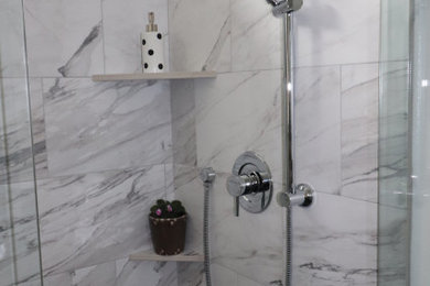 Bathroom - mid-sized transitional master white tile porcelain tile, black floor and double-sink bathroom idea in Other with shaker cabinets, gray cabinets, a two-piece toilet, white walls, an undermount sink, quartz countertops, a hinged shower door, gray countertops and a built-in vanity
