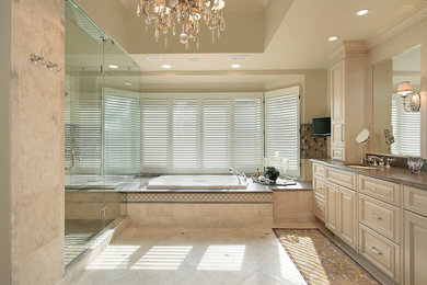 Inspiration for a large timeless master beige floor, single-sink, tray ceiling and wood wall bathroom remodel in Atlanta with raised-panel cabinets, beige cabinets, beige walls, marble countertops, a hinged shower door, beige countertops and a built-in vanity