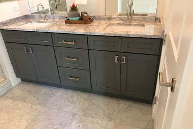 Bathroom - mid-sized contemporary master white tile and marble tile marble floor and white floor bathroom idea in New Orleans with shaker cabinets, gray cabinets, a two-piece toilet, white walls, an undermount sink, marble countertops and a hinged shower door