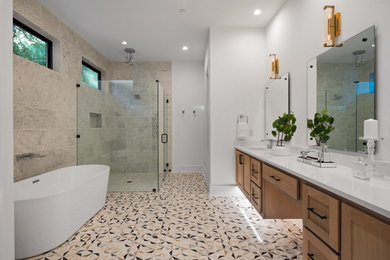 Example of a huge transitional master multicolored tile and stone tile multicolored floor and double-sink bathroom design in Austin with shaker cabinets, medium tone wood cabinets, a one-piece toilet, white walls, an undermount sink, quartz countertops, a hinged shower door, white countertops and a floating vanity