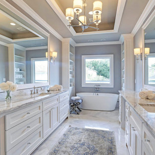 Example of a mid-sized arts and crafts master marble floor, multicolored floor, double-sink and coffered ceiling bathroom design in Houston with shaker cabinets, white cabinets, gray walls, an undermount sink, marble countertops, a hinged shower door, multicolored countertops and a built-in vanity