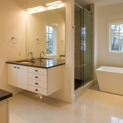 Bathroom - large modern master white tile marble floor and beige floor bathroom idea in DC Metro with flat-panel cabinets, white cabinets, a two-piece toilet, white walls, an undermount sink, quartz countertops and gray countertops