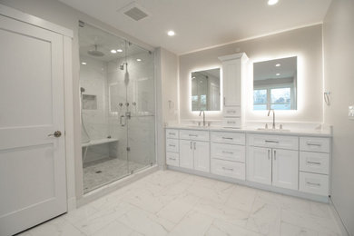 Example of a large trendy master ceramic tile and white tile ceramic tile, white floor and double-sink bathroom design in Chicago with shaker cabinets, white cabinets, a one-piece toilet, white walls, an undermount sink, quartzite countertops, a hinged shower door, white countertops and a built-in vanity