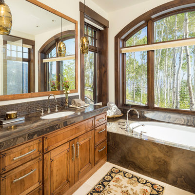 Bathroom - huge rustic brown tile and mosaic tile beige floor bathroom idea in Salt Lake City with marble countertops, recessed-panel cabinets, medium tone wood cabinets, an undermount tub, white walls, an undermount sink and brown countertops