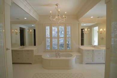 Example of a large transitional master beige tile, white tile and porcelain tile marble floor alcove shower design in Atlanta with shaker cabinets, white cabinets, an undermount tub, a two-piece toilet, beige walls, an undermount sink and quartz countertops