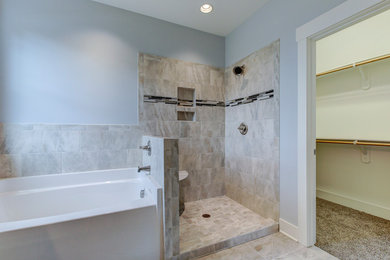 Example of a large arts and crafts master gray tile and ceramic tile porcelain tile and gray floor bathroom design in Raleigh with shaker cabinets, white cabinets, a one-piece toilet, gray walls, an undermount sink, granite countertops, a hinged shower door and gray countertops