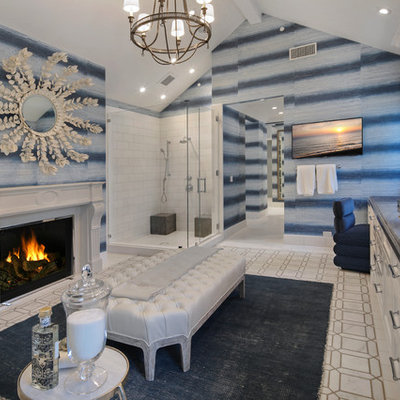 Corner shower - coastal master white tile gray floor corner shower idea in Orange County with recessed-panel cabinets, white cabinets, blue walls, an undermount sink, a hinged shower door and blue countertops
