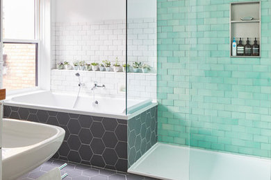 Large scandi ensuite bathroom in Toronto with a built-in bath, a built-in shower, a wall mounted toilet, green tiles, metro tiles, white walls, ceramic flooring, a wall-mounted sink, grey floors and an open shower.