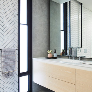 Design ideas for a modern bathroom in Melbourne with flat-panel cabinets, light wood cabinets, white tile, an integrated sink, grey floor and white benchtops.