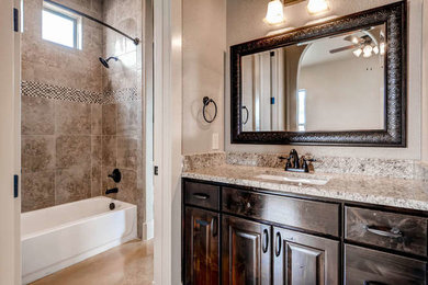 Photo of a classic bathroom in Austin with raised-panel cabinets, dark wood cabinets, an alcove bath, a shower/bath combination, beige walls, concrete flooring, a submerged sink, granite worktops, beige floors and an open shower.