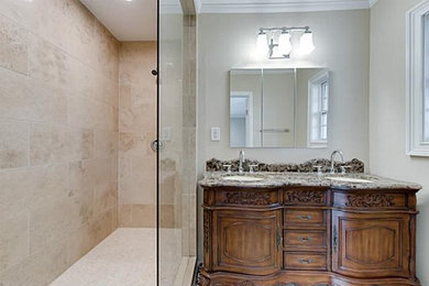 Mid-sized elegant master beige tile and ceramic tile alcove shower photo in Dallas with flat-panel cabinets, dark wood cabinets, gray walls, an undermount sink and granite countertops