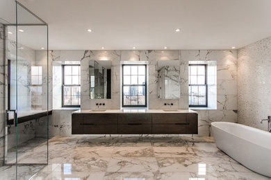 Example of a large trendy master white tile and marble tile marble floor and multicolored floor bathroom design in Montreal with flat-panel cabinets, dark wood cabinets, an undermount sink, white walls, solid surface countertops and a hinged shower door