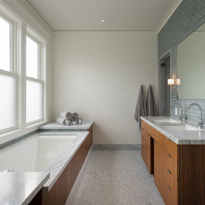 Inspiration for a contemporary gray tile and subway tile mosaic tile floor bathroom remodel in San Francisco with an undermount sink, flat-panel cabinets, medium tone wood cabinets, an undermount tub and gray countertops