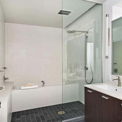 Example of a mid-sized minimalist white tile bathroom design in San Francisco with flat-panel cabinets, dark wood cabinets, white walls and an undermount sink