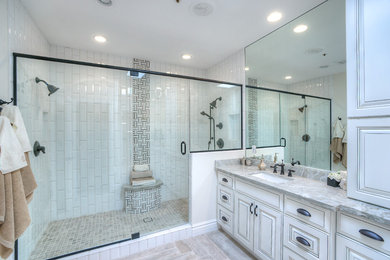 Mid-sized arts and crafts 3/4 multicolored tile double shower photo with light wood cabinets, a one-piece toilet, beige walls, a drop-in sink and marble countertops