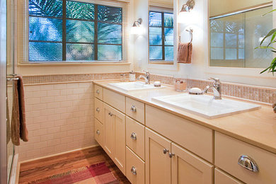 Alcove shower - small traditional 3/4 white tile and subway tile light wood floor alcove shower idea in Phoenix with an undermount sink, shaker cabinets, beige cabinets, quartz countertops, a one-piece toilet and beige walls