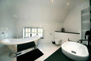 Design ideas for a large contemporary family bathroom in Other with flat-panel cabinets, black cabinets, a freestanding bath, a walk-in shower, a wall mounted toilet, black and white tiles, marble tiles, white walls, porcelain flooring, a vessel sink, marble worktops, white floors, an open shower and black worktops.