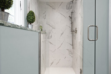 Small transitional 3/4 white tile and porcelain tile porcelain tile and black floor alcove shower photo in Boston with shaker cabinets, white cabinets, a two-piece toilet, blue walls, an undermount sink, quartz countertops, a hinged shower door and multicolored countertops