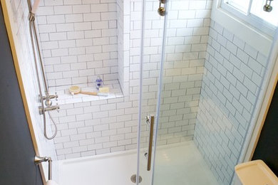 Small traditional shower room bathroom in Providence with dark wood cabinets, an alcove shower, a two-piece toilet, white tiles, metro tiles, blue walls, porcelain flooring, an integrated sink, solid surface worktops and beaded cabinets.