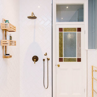 Mid-sized trendy white tile and subway tile laminate floor and beige floor bathroom photo in London with blue walls