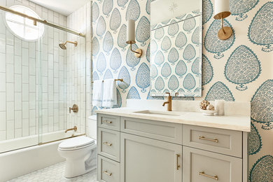 Example of a beach style white tile bathroom design in Charlotte with recessed-panel cabinets, gray cabinets, a two-piece toilet and multicolored walls