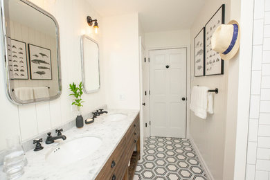 Example of a mid-sized farmhouse kids' ceramic tile marble floor and black floor bathroom design in New York with distressed cabinets, a two-piece toilet, white walls, an undermount sink and marble countertops